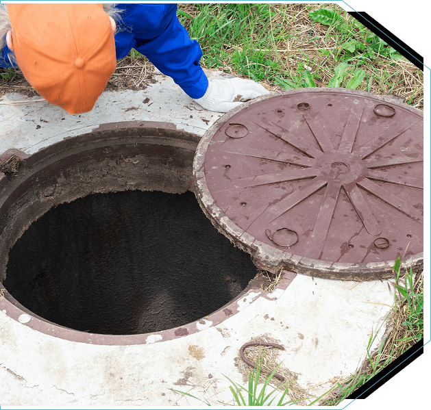 Group 5 (8) A man is standing next to a manhole cover.