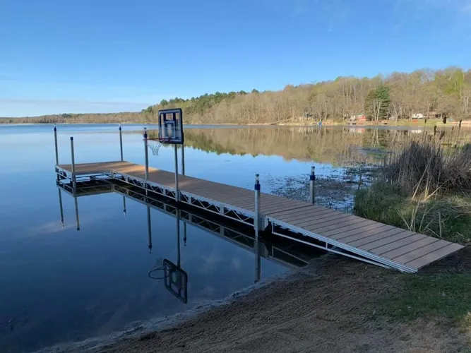 cr=w_667,h_500 A dock with a sign on it near the water.